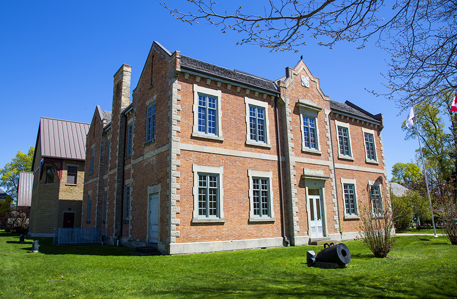 Huron County Museum. View of original school house building. Blue sky above.