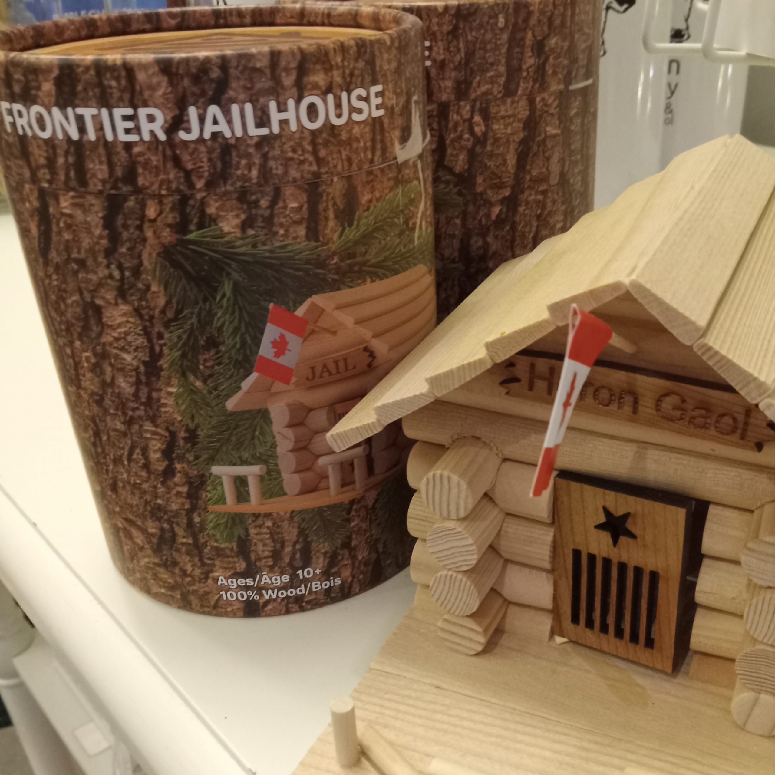 Image of the Frontier Jailhouse log cabin kit with completed version of the kit.