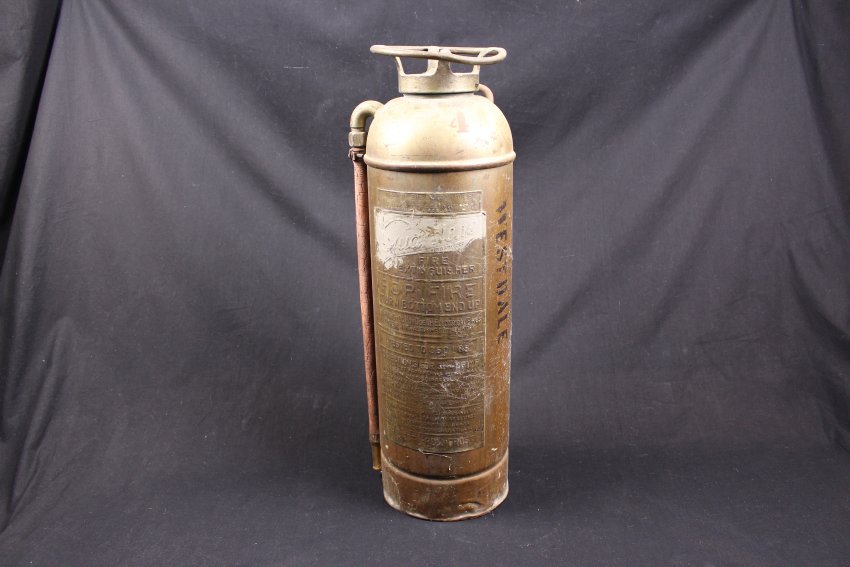 large brass fire extiguisher --  2 1/2 galloncylindrical with red rubber hose that has cracked and hardened;  stenciled in black on side is "WESTDALE". Instructions on side.  "Guardene Extinguisher" 