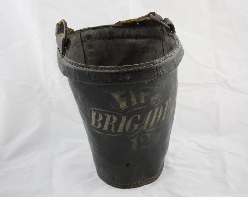 Black bucket with 'Fire Brigade' written on it.
