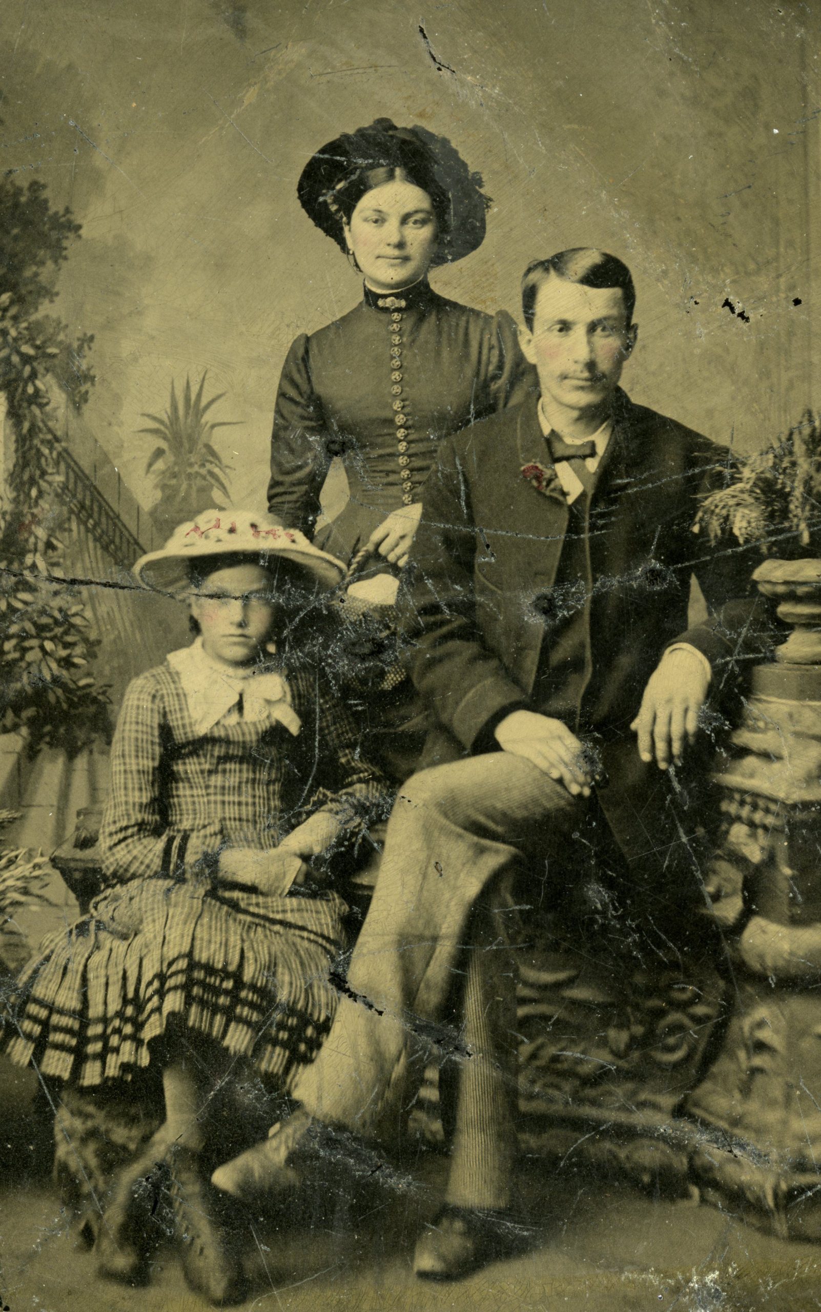 Historic image taken in a portrait studio of Joseph Hodskinson, his wife Margaret and young daughter Celina.