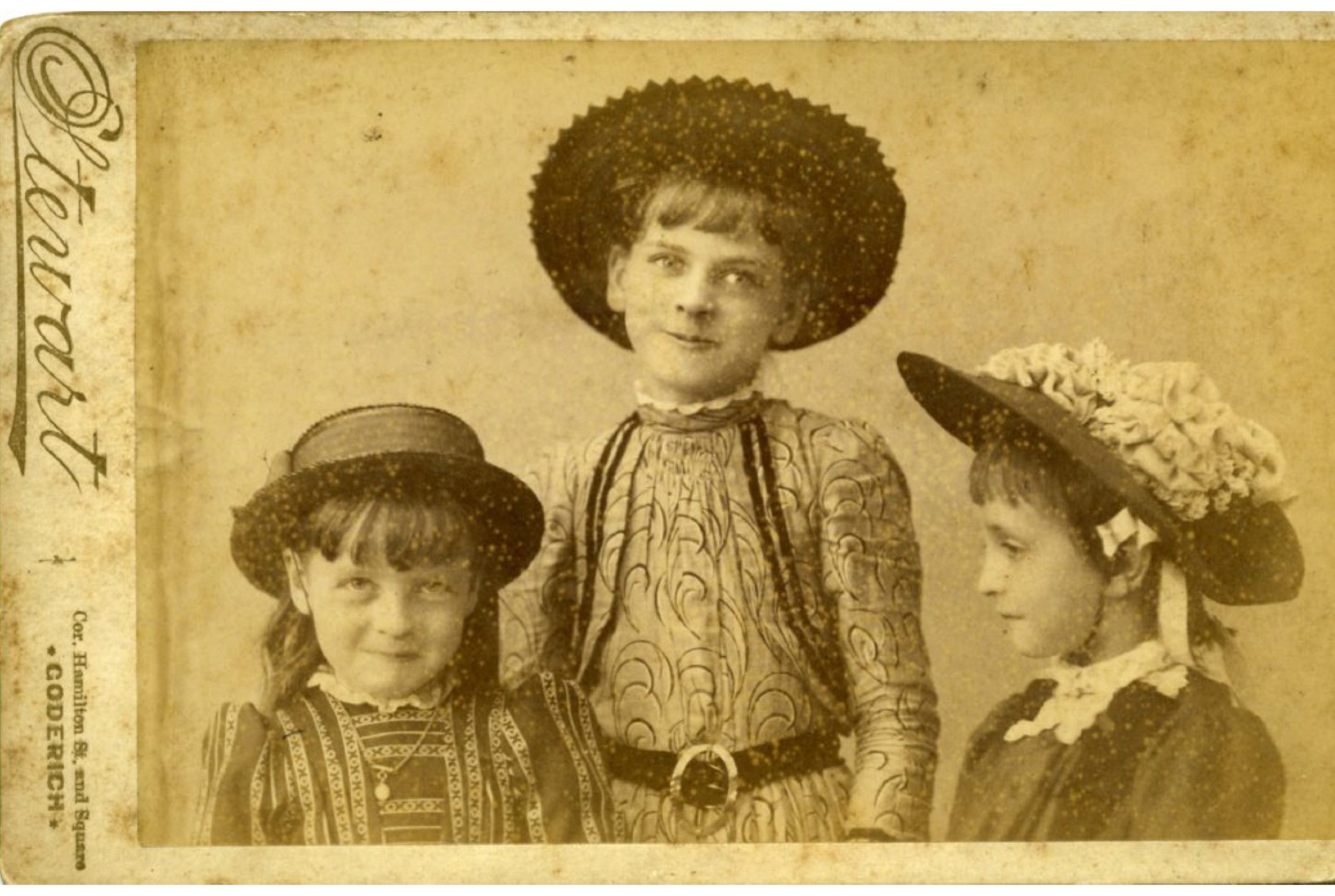 Historic image of three girls wearing hats
