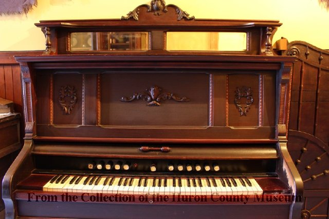 Image of Mahogany pump organ manufactured by W. Doherty Piano & Organ Co, Clinton, Ontario, which produced organs from 1875 to 1960’s. Object ID M995.0007.001